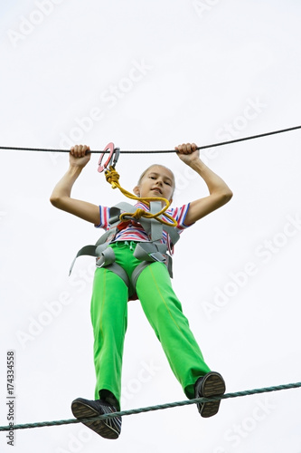 Teenage girl walking on a rope
