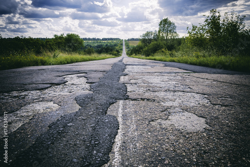 Bad road with damaged and broken asphalt, Difficult life concept
