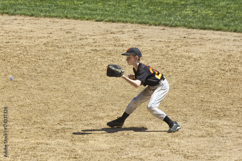 Fielder Catching Line Drive in Youth Baseball Game