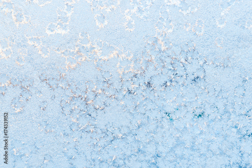 Ice pattern on the frosty window. Beautiful winter background.