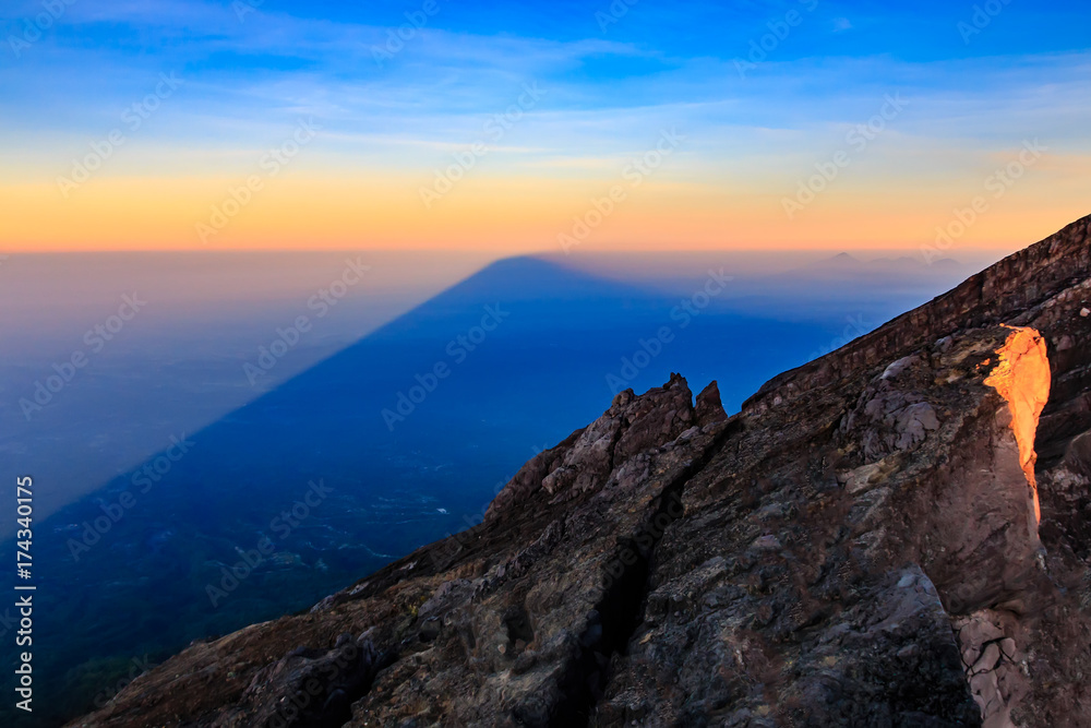 Mount Agung volcano casts its huge shadow over the island of Bali at sunrise