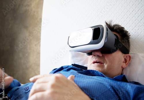 Senior man with virtual headset or 3d glasses. photo