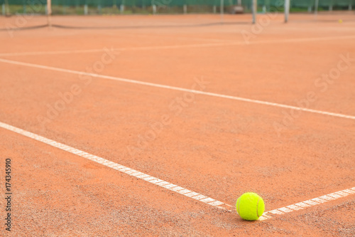 Tennis ball on modern court © Africa Studio