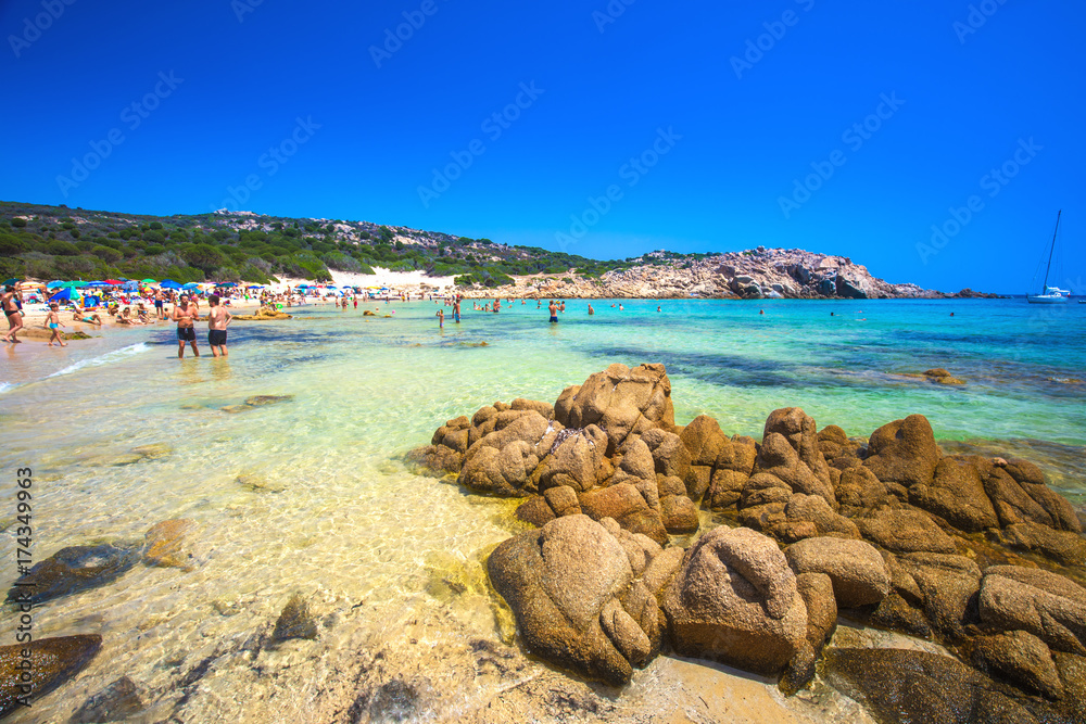 Cala Cipolla, Chia beach with red stones and azure clear water, Sardinia, Italy