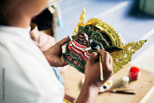 Artisan painting 'Hua Khon' traditional mask for Thai performing arts photo