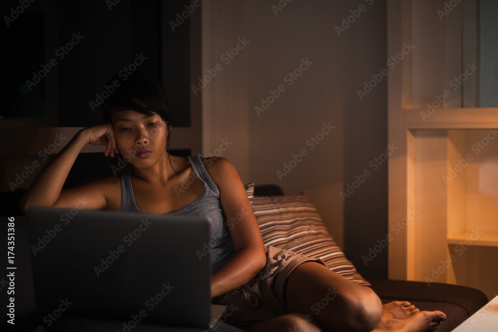Modern woman in casual outfit using her laptop during evening. Modern woman in casual outfit using her laptop during evening.