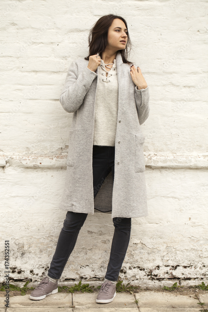 Brunette woman in a gray woolen coat