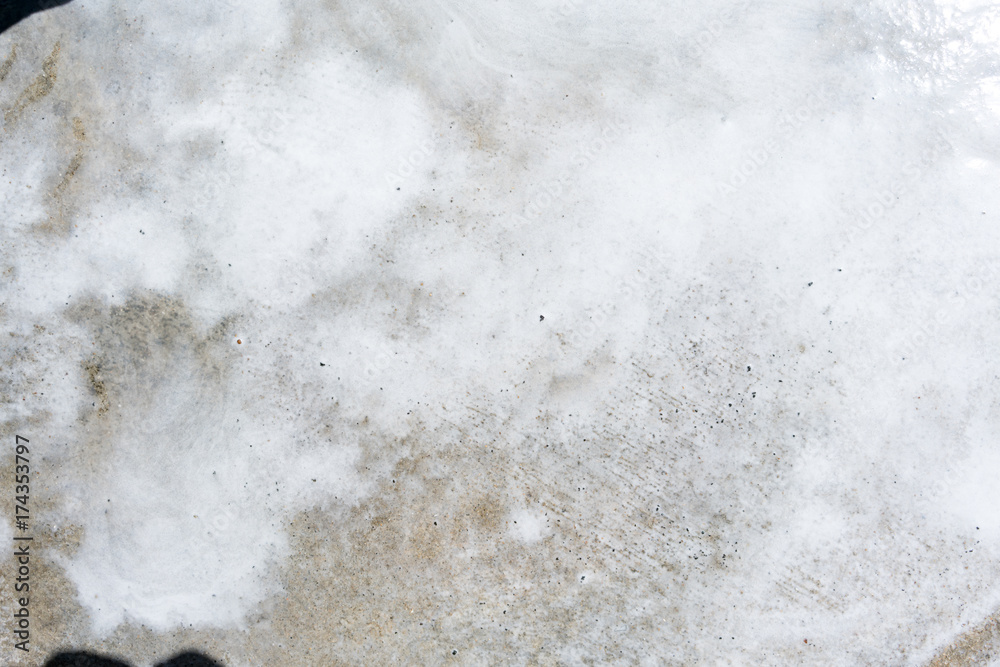 Abstract white foam flow with water on dirty concrete floor for texture background Abstract white foam flow with water on dirty concrete floor for texture background