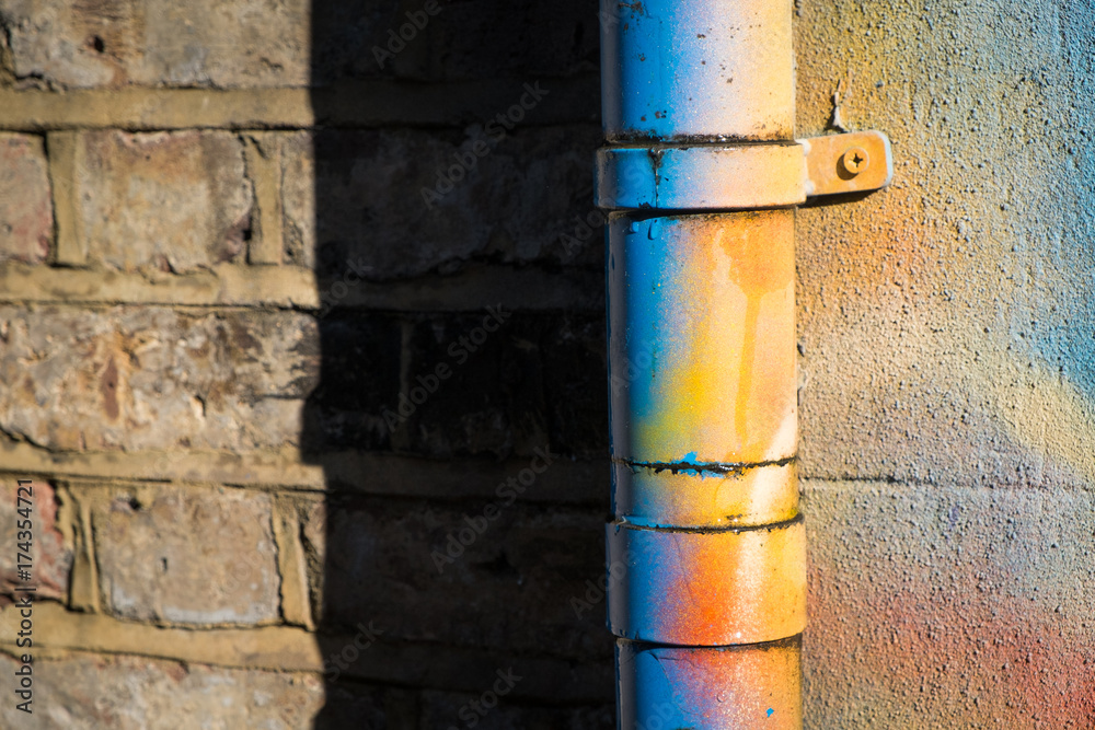 Drainpipe covered in bright spraypaint