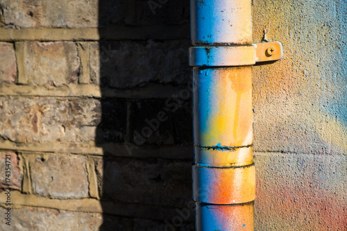 Drainpipe covered in bright spraypaint