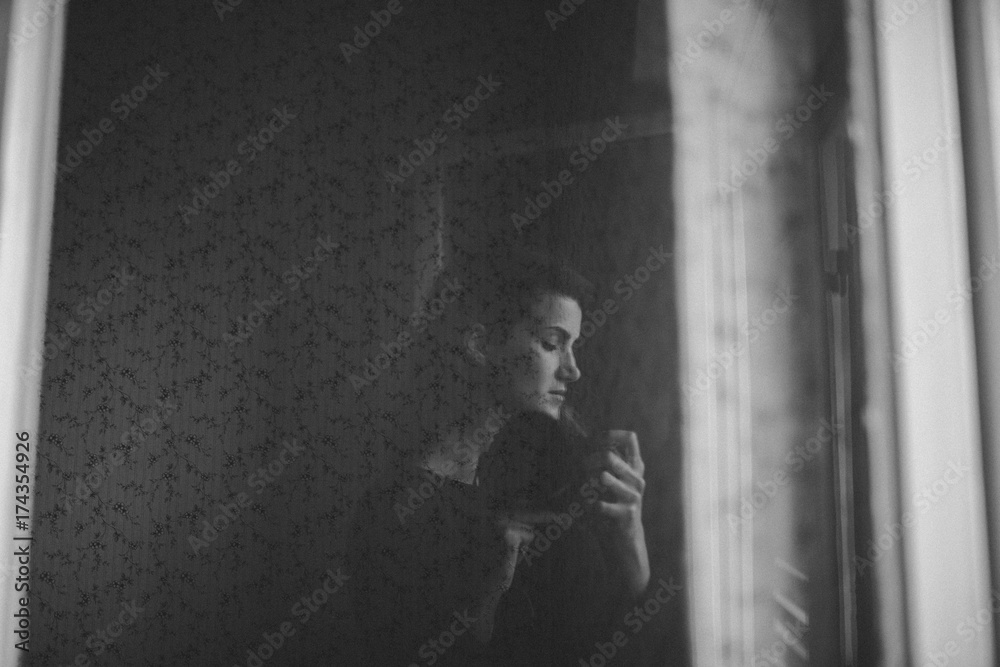 Self portrait in a reflective window in black and white Self portrait in a reflective window in black and white