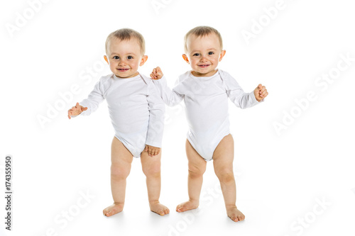 Obraz na plátne Two identical twins on a white isolated background