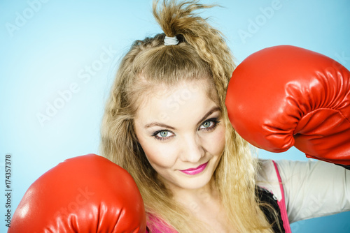 Funny girl in red gloves playing sports boxing © Voyagerix
