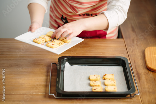 Young Chinese woman baking cookies