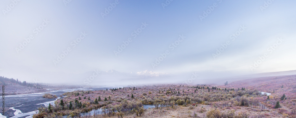 The Alaskan Mountain Range emerges through fog The Alaskan Mountain Range emerges through fog