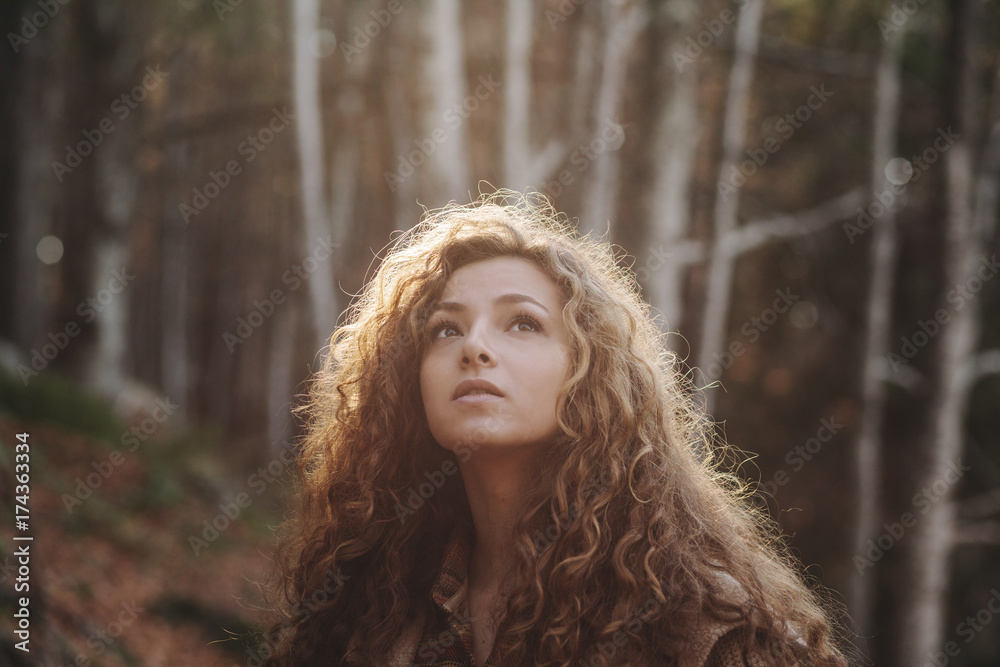 Young woman looking around in the forest Young woman looking around in the forest