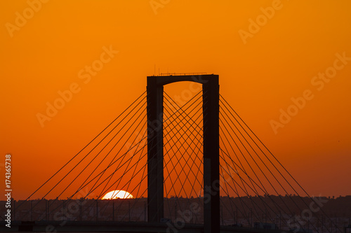 Fototapeta Naklejka Na Ścianę i Meble -  SEVILLE, SPAIN - AUGUST 21, 2017: Fifth Centenary Bridge with partial eclipse sunset