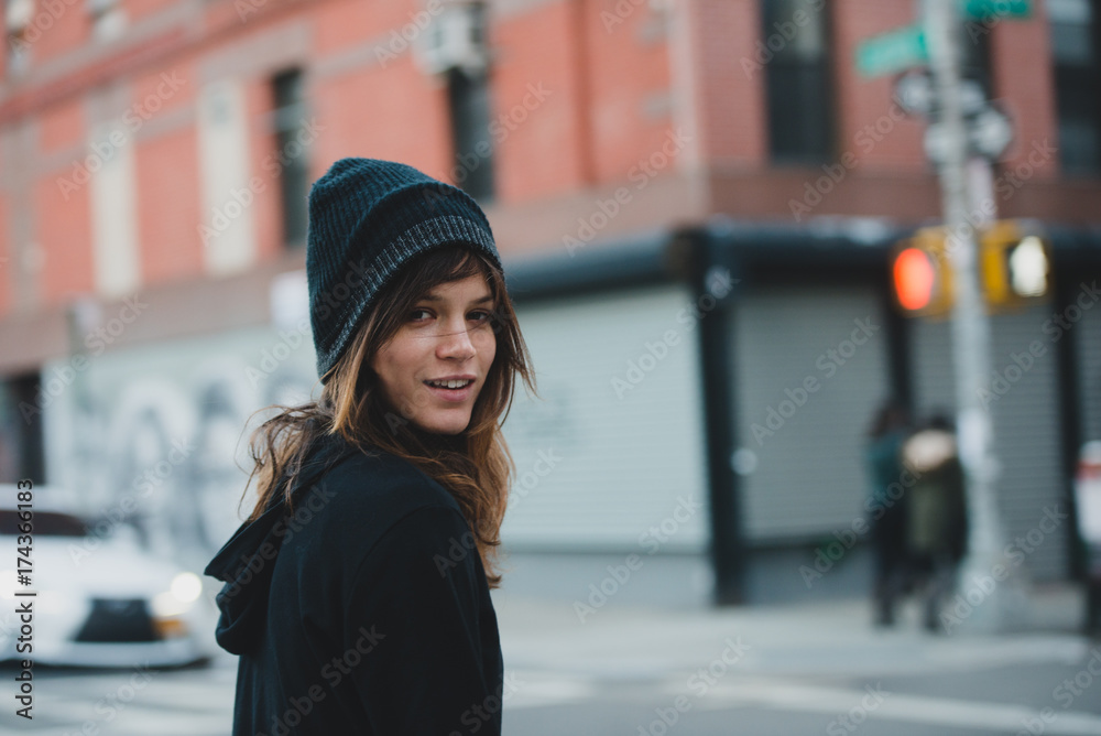 Beautiful young woman walking down the street in the city Beautiful young woman walking down the street in the city