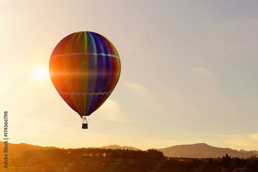 Aerostat floating in day sky. Mixed media