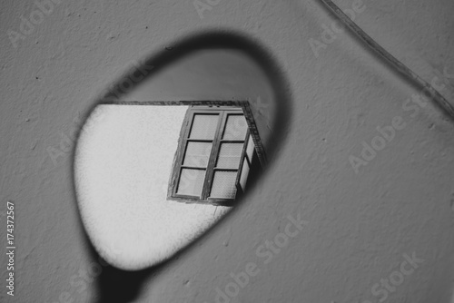 window reflect in a car rearview mirror
