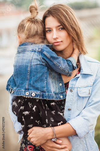 Mother embracing her 3 year old daugher