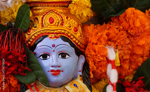 Fototapeta Naklejka Na Ścianę i Meble -  Hindu Goddess asta lakshmi idol on Flower arrangement called Bathukamma during Dussera celebrations