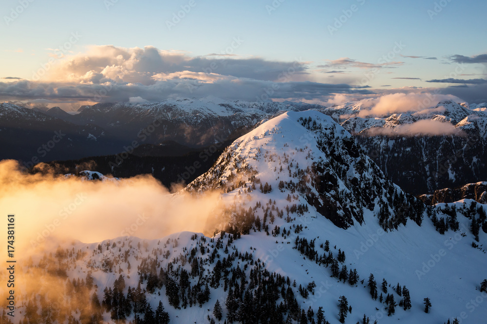 Beautiful Aerial Landscape View of Coquitlam Mountain during a colorful cloudy sunset. Taken in Vancouver, British Columbia, Canada.