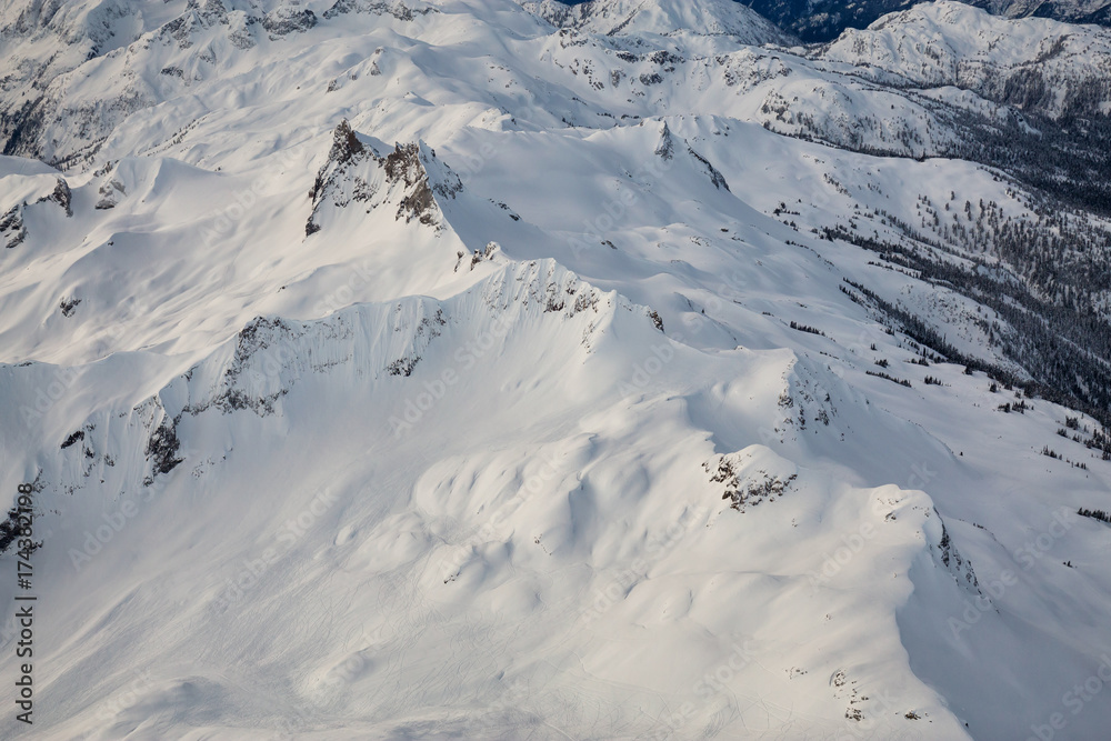Scenic aerial landscape view of the beautiful snow covered mountains of British Columbia, Canada. Picture taken during winter near Whistler, BC. Scenic aerial landscape view of the beautiful snow covered mountains of British Columbia, Canada. Picture taken during winter near Whistler, BC.