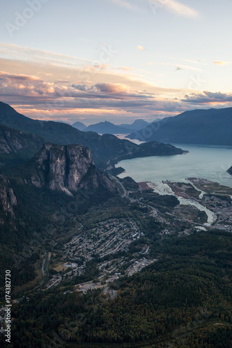 Aerial view of a small town, Squamish, in British Columbia, Canada, with the Chief Mountain and Howe Sound in the background.