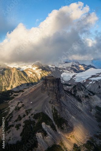 Beautiful aerial landscape view of snow covered mountains with a colorful morning sky. Picture taken of Black Tusk in Garibaldi, British Columbia, Canada.