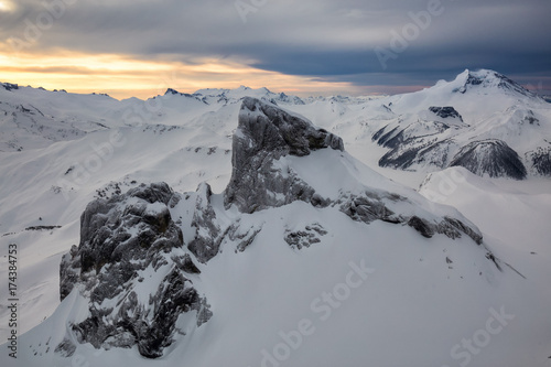 Beautiful aerial landscape view of snow covered mountains with a colorful morning sky. Picture taken of Black Tusk in Garibaldi  British Columbia  Canada.