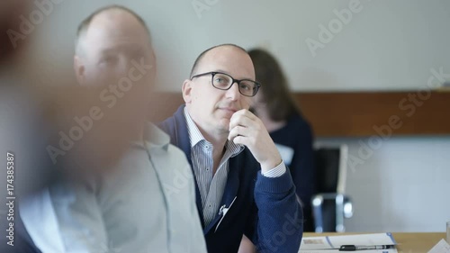  Real business group listening to the speaker at a business seminar