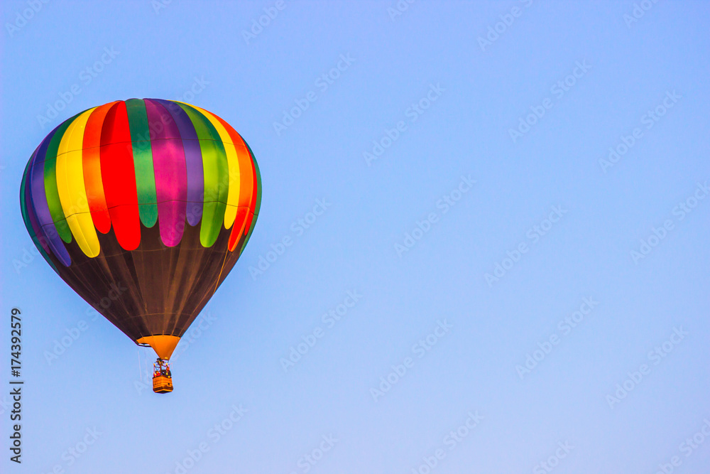Multi Colored Hot Air Balloon Above Tree Line Multi Colored Hot Air Balloon Above Tree Line