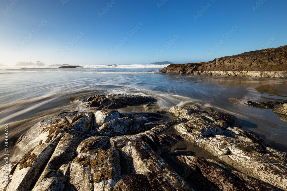 Long exposure landscape picture of a rocky beach on Pacific Ocean Coast. Picture taken at Chesterman, Tofino, Vancouver Island, British Columbia, Canada, during a winter morning. Long exposure landscape picture of a rocky beach on Pacific Ocean Coast. Picture taken at Chesterman, Tofino, Vancouver Island, British Columbia, Canada, during a winter morning.
