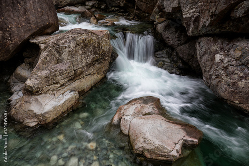 Fototapeta Naklejka Na Ścianę i Meble -  Nature landscape of a waterfall and river flowing in a canyon. Picture taken in Widgeon Falls, Greater Vancouver, British Columbia, Canada.