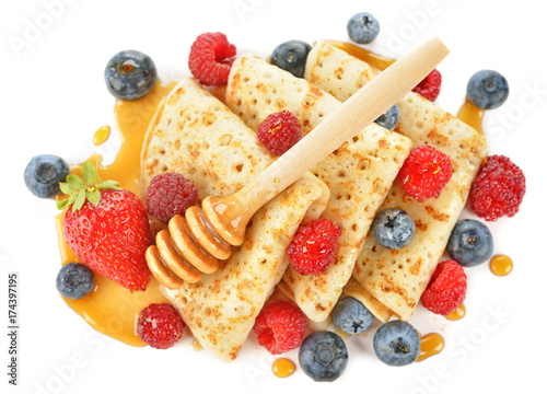 French crepes with berries and honey photo