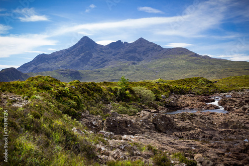 Mountain peaks of Cuillin and a meandering stream landscape  at Tir Nan Iolaire or the Land of Eagles on the Isle of Skye in Scotland.