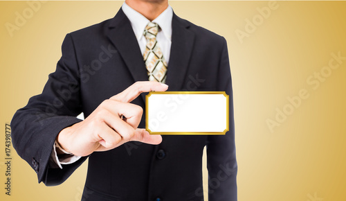 Fototapeta Naklejka Na Ścianę i Meble -  Close up of business man holding white blank card gold border with copyspace ready for your text or letters