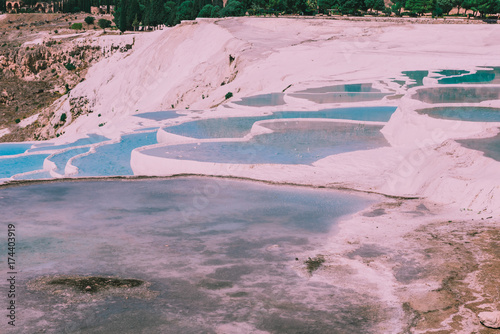 Turquoise color view of Pamukkale (Cotton Castle) is popular with Travertine pools and terraces where people love to visit in Pamukkale, Turkey.