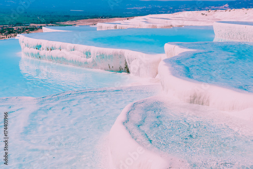 Turquoise color view of Pamukkale (Cotton Castle) is popular with Travertine pools and terraces where people love to visit in Pamukkale, Turkey.