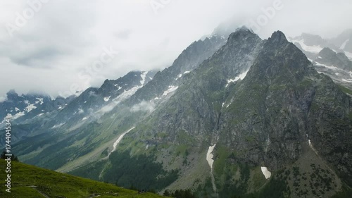 Timelapse: Clouds and storm move in to the mountains of the Alps across the valley from the Walter Bonatti Hut and refugio in Italy. Tour du Mont Blanc.