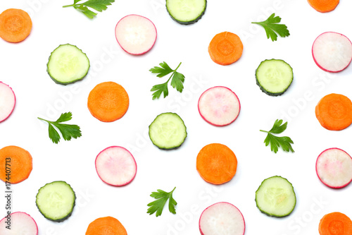 mix of sliced cucumber with sliced carrot isolated on a white background top view