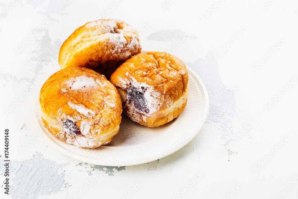 Tasty homemade donuts with jam on white background. Copy space