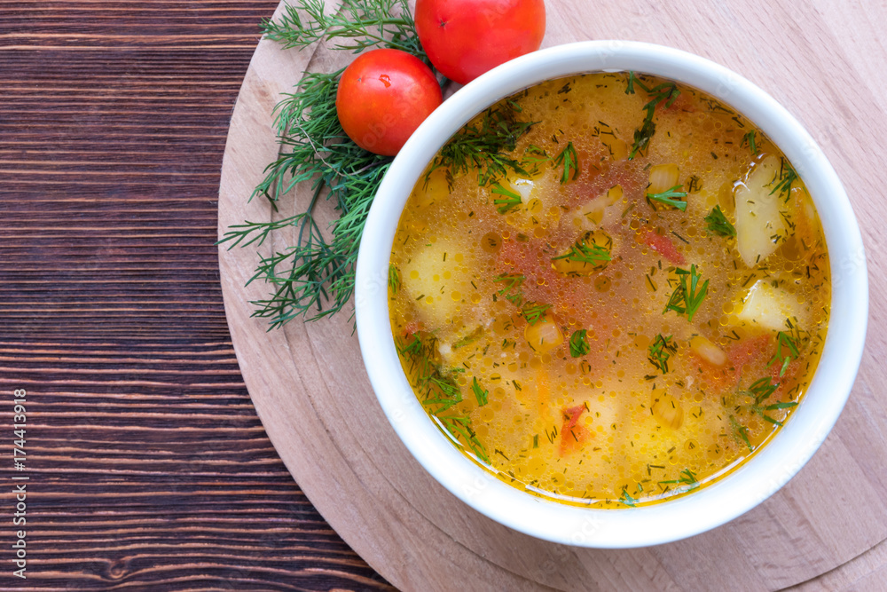 White soup noodles with tomatoes. Potatoes, dill, spices. On a wooden Board. White soup noodles with tomatoes. Potatoes, dill, spices. On a wooden Board.