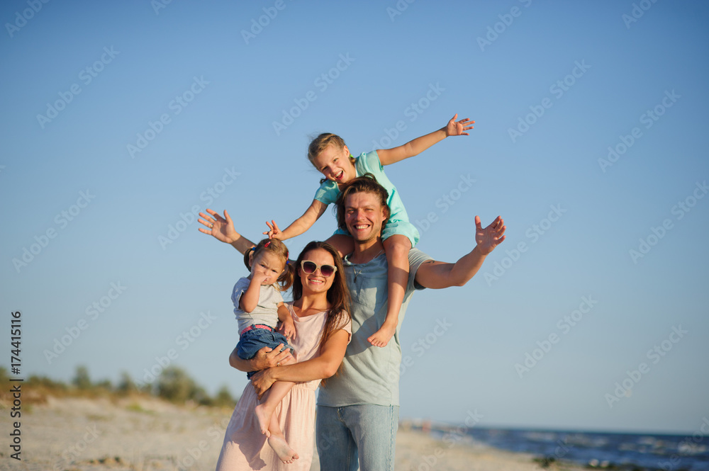 Young happy family on the beach. Young happy family on the beach.