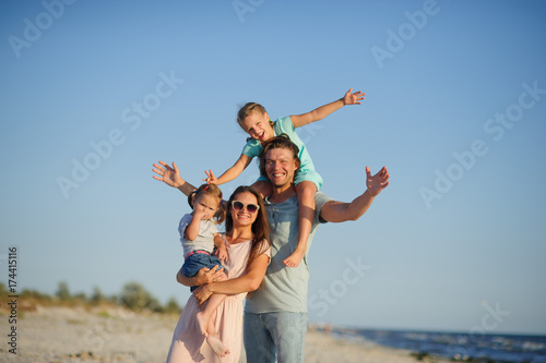 Young happy family on the beach.