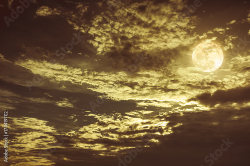 Beautiful night sky with dark cloudy. Some clouds overshadow the full moon.