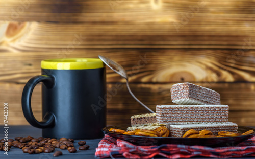 chocolate wafers and coffee on a dark background 
