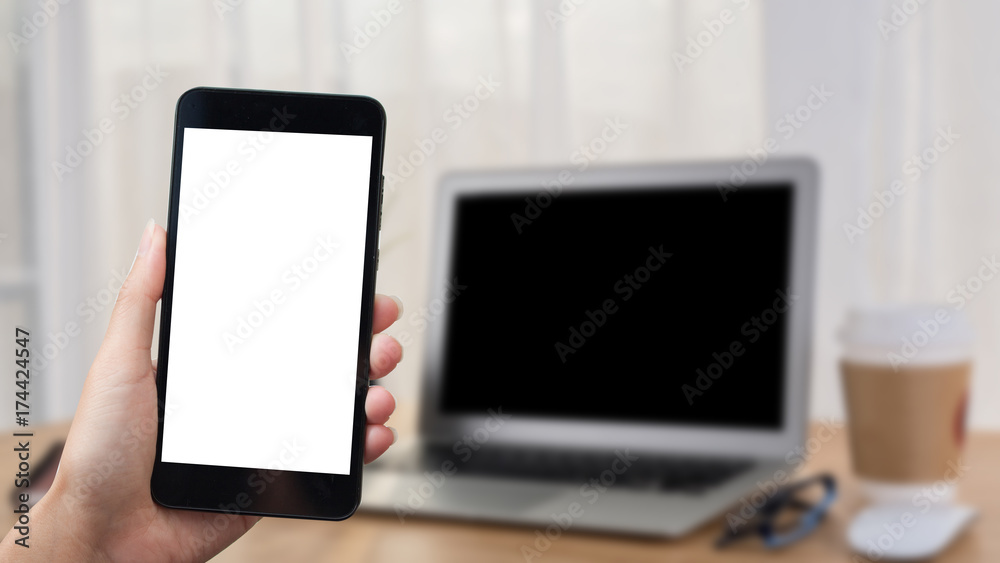 Asian woman hand holding smart phone on background workplace table. Asian woman hand holding smart phone on background workplace table.