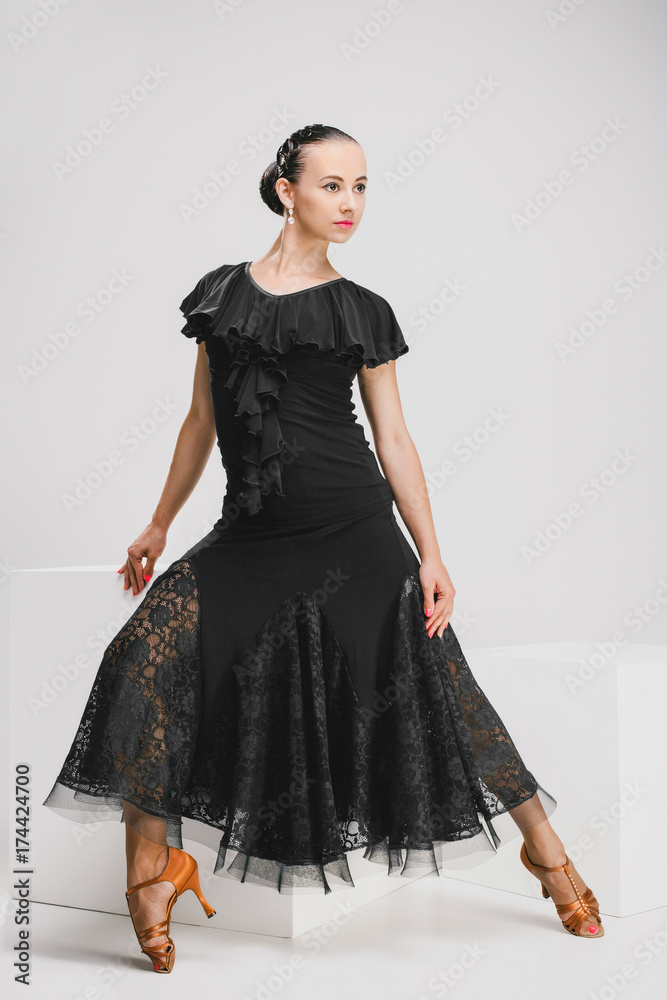 Fototapeta premium woman in black dress sitting in studio